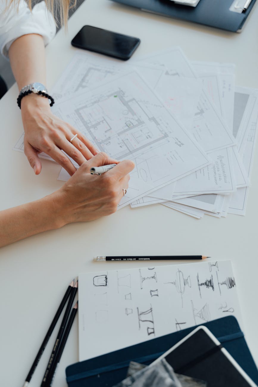 architect writing on floor plans